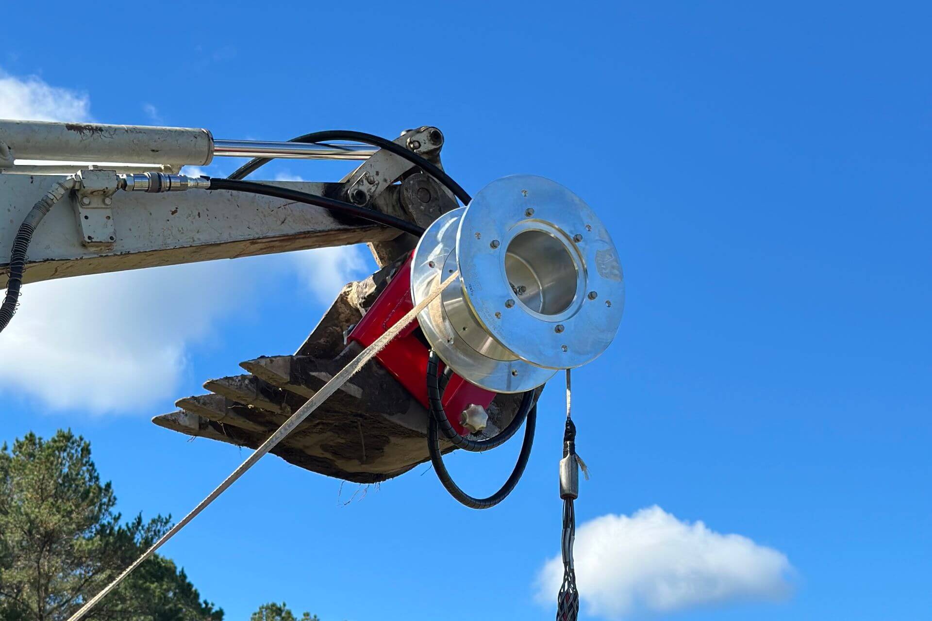 Closeup of Willy Winch raised in the air by excavator
